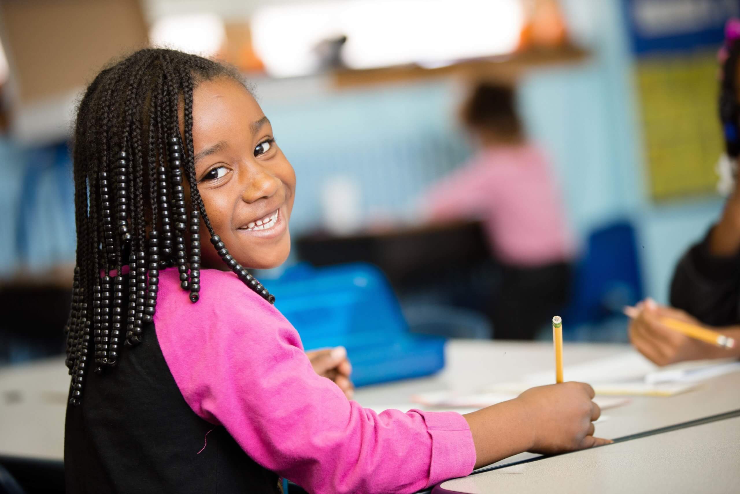 student girl smiling at her desk