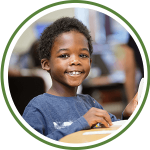 child smiling in class in a circle image